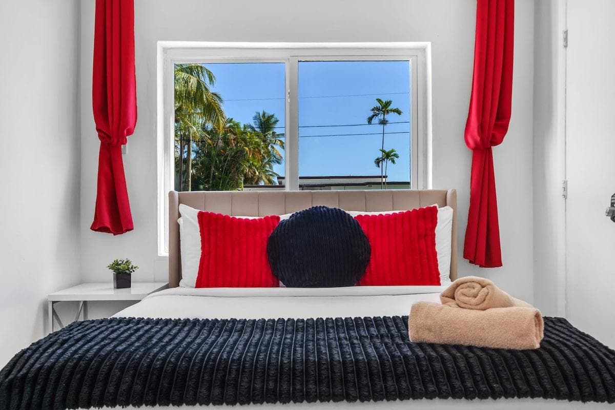 Located on the first level, Red Bedroom 1 features a queen-size bed, blackout curtains, a dedicated office desk, and a closet. Perfect for business or leisure travelers seeking privacy, comfort, and convenience.