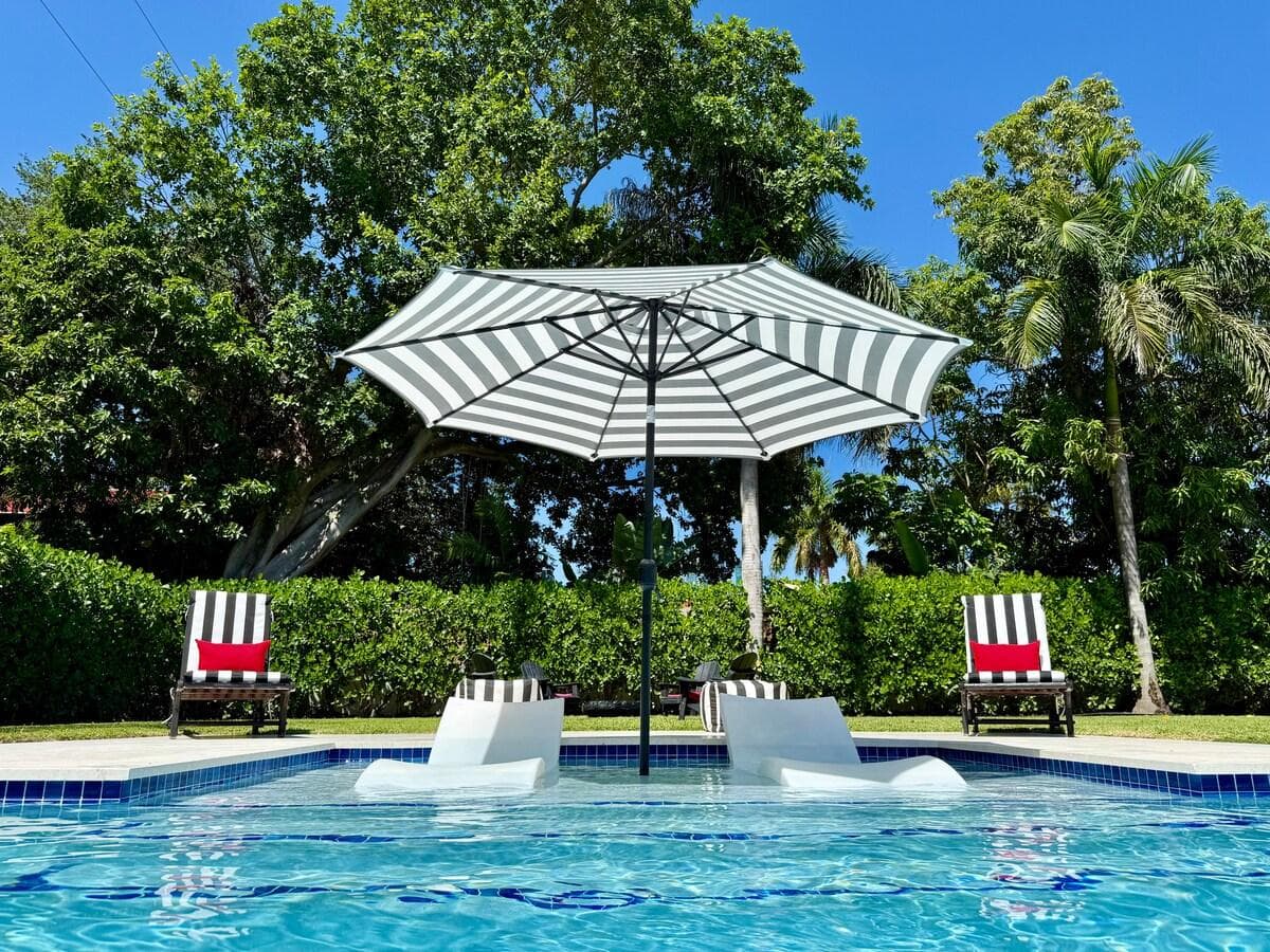 Experience Art Deco luxury in the backyard with a year-round heated pool and spa, featuring an in-pool tanning chair. Relax in the stylish outdoor seating area, dine at the elegant table for eight, enjoy the BBQ—perfect for upscale al fresco living!